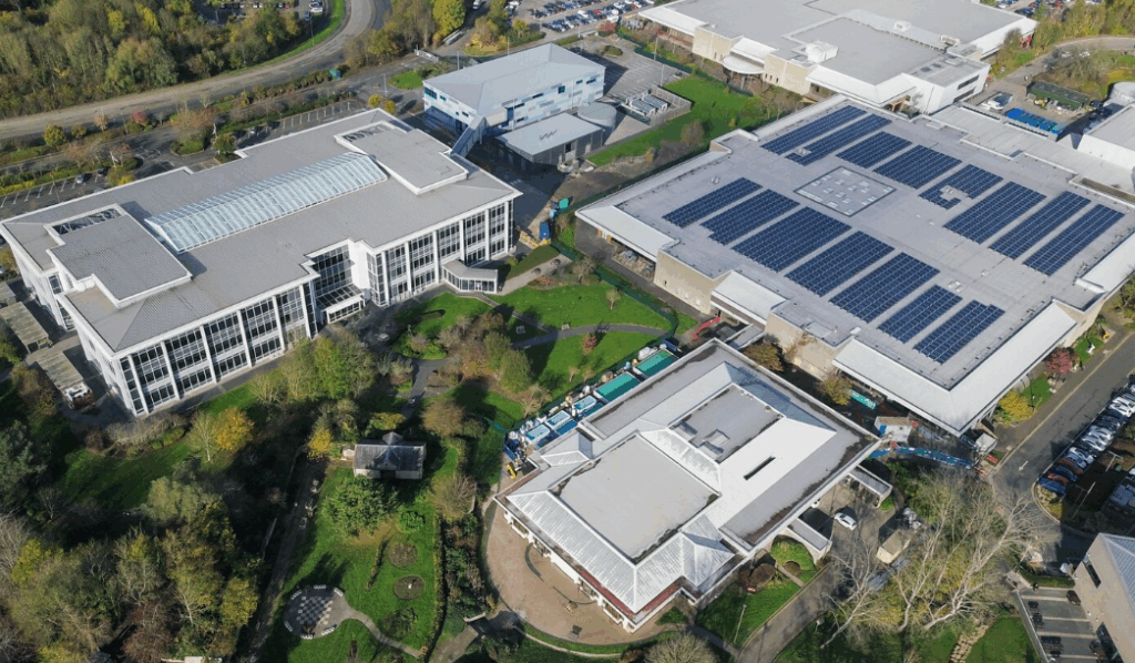 Aerial view of factory roofs covered in solar panels, highlighting greener fabs in the post-microchip shortage era.
